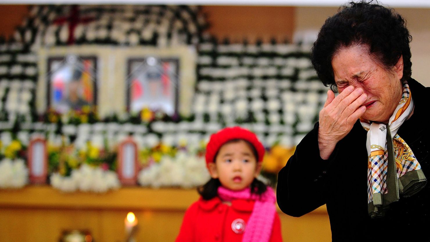 A relative of a marine killed by North Korean shelling on Yeonpyeong weeps during a memorial service on November 25, 2010.    