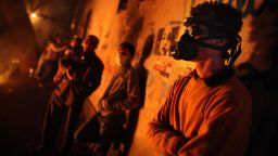Protestors wearing gas masks gather near Cairo's Tahrir Square during clashes with police on November 23, 2011.  