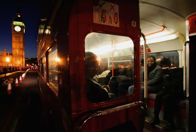 Passengers inside an old Routemaster, as seen from the open platform at the rear. 