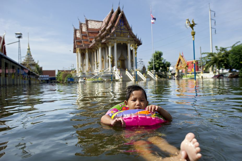 A young girl swims in flood waters near Bangkok airport. The Thai capital was subjected to the worst flooding in living memory during the 2011 monsoon season. 