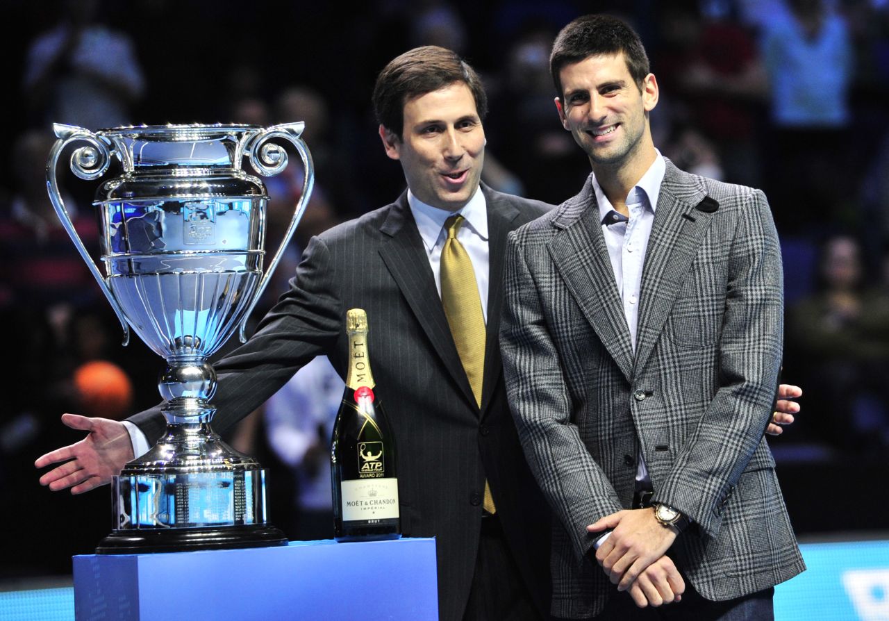 ATP World Tour executive chairman and president Adam Helfant, left, presents top-ranked Novak Djokovic with the player of the year trophy this week -- and a bottle of champagne provided by sponsor Moet & Chandon.
