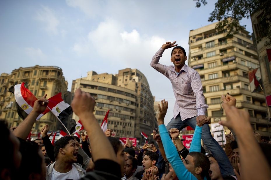 A protester leads chants Friday, November 25, in Cairo's Tahrir Square, where sometimes-violent rallies have taken place for a week. Egyptian military leaders said Thursday that parliamentary elections scheduled for Monday, November 28, will take place as planned, despite recent violence that claimed dozens of lives.