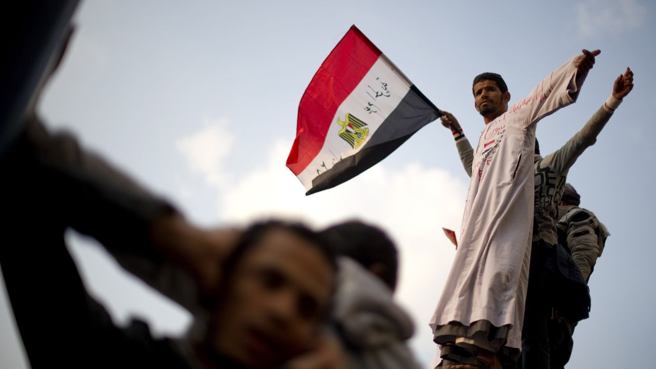 A protester waves his national flag during a rally at Tahrir Square on Thursday. Protesters demanded an end to military rule.