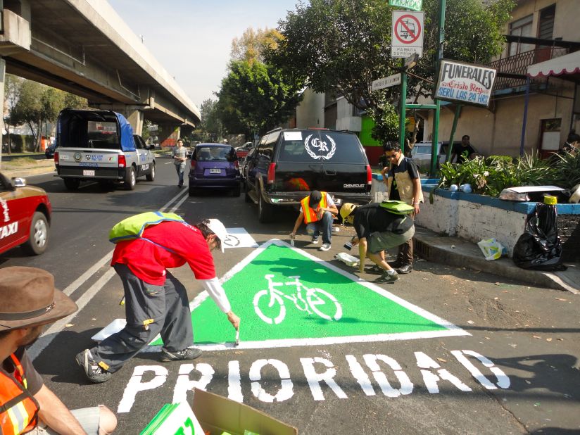 A group of urban activists paint an unauthorized  "wikilane" cycle path in the middle of Mexico City.