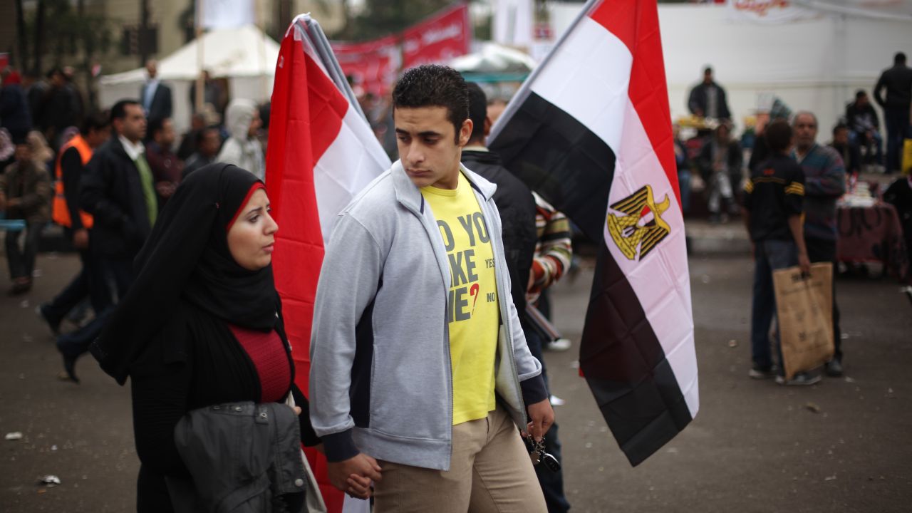 A couple walk in Cairo's Tahrir Square, where protesters continue to camp ahead of elections, on November 27.