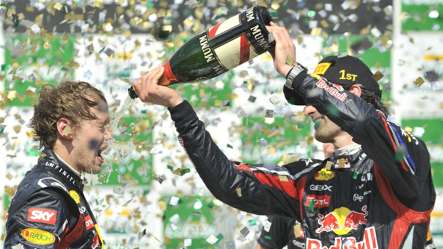 Brazil winner Mark Webber pours champagne on teammate and champion Sebastian Vettel.
