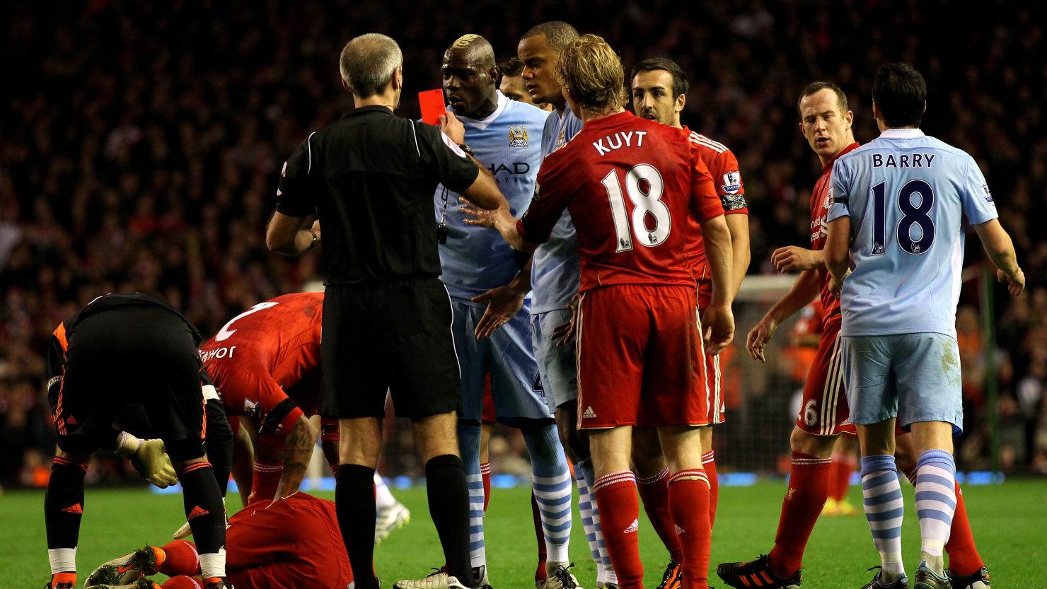 Mario Balotelli is shown red by referee Martin Atkinson in Manchester City's 1-1 draw at Liverpool.