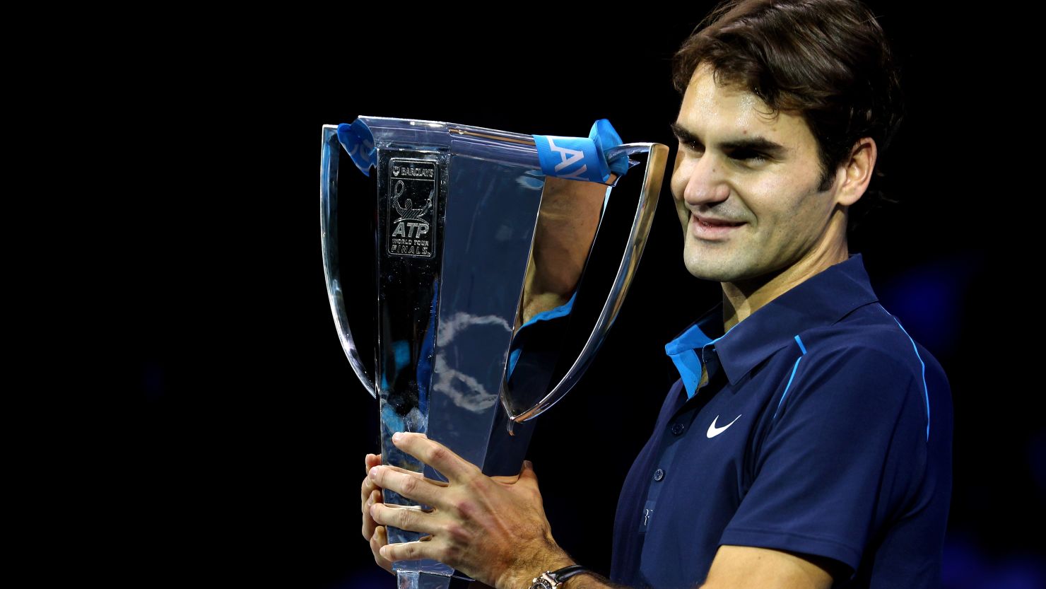 Roger Federer holds aloft the ATP World Tour Finals crown after beating Jo-Wilfried Tsonga.