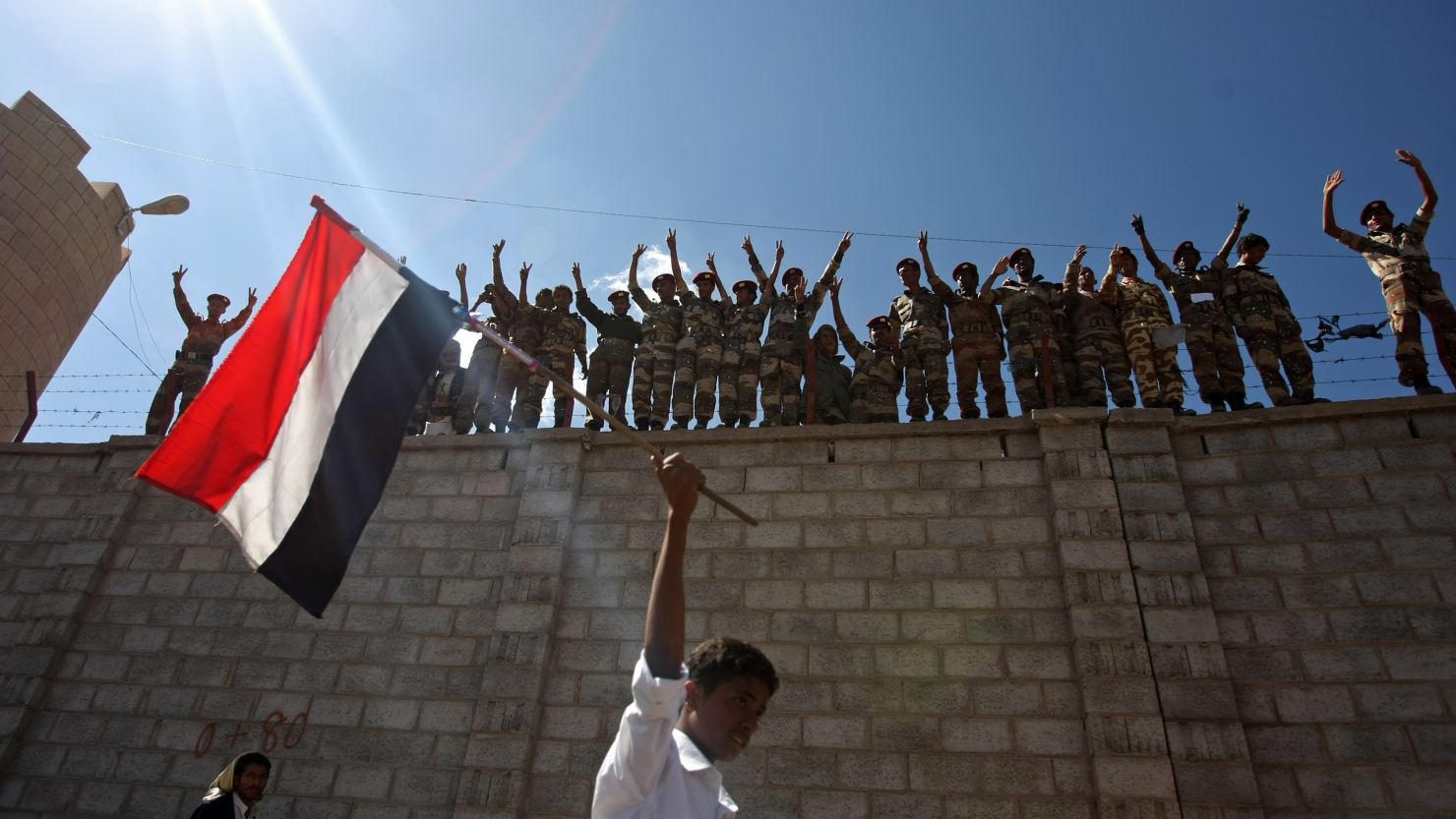 Dissident Yemeni protesters shout slogans as a protestor waves a Yemeni flag in Sanaa on Saturday.