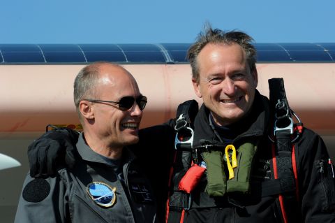 Bertrand Piccard (left) and Andre Borschberg pose beside the aircraft.