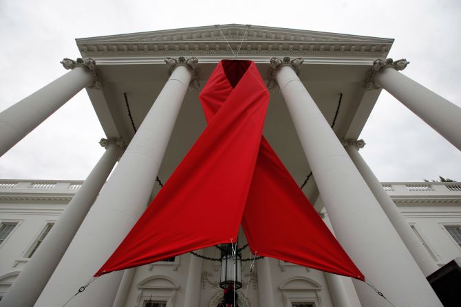 A red ribbon is hung between columns on the north side of the White House to commemorate World AIDS Day on November 30, 2010, in Washington.