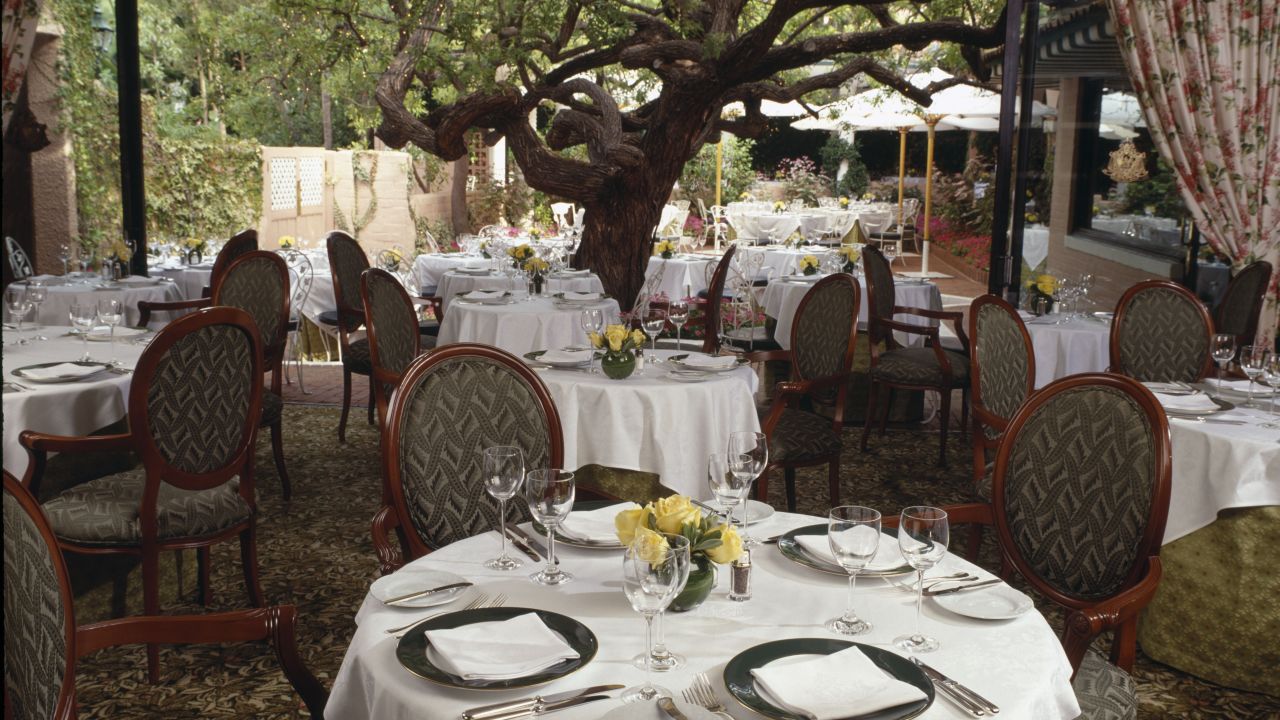 The Polo Lounge, here shown uncharacteristically empty, offers interior and outdoor power dining.