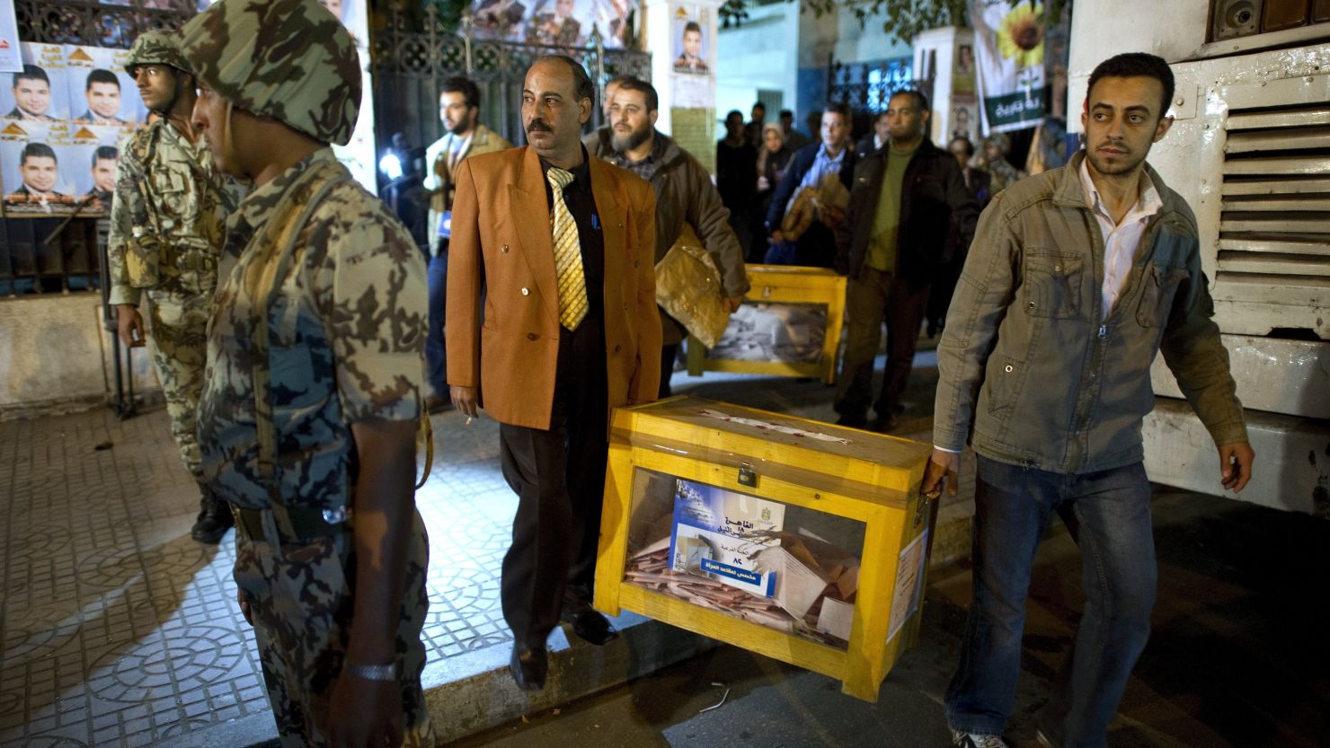 Election officials remove ballot boxes from a polling station near Tahrir Square at the end of the voting day in Cairo on Tuesday.
