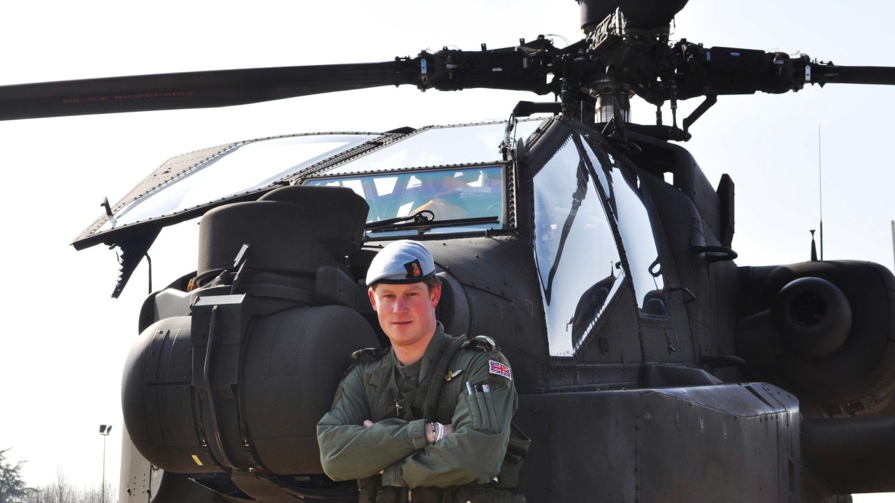 Prince Harry stands in front of an Apache helicopter on March 21, 2011, a few days after he was promoted to the rank of captain.