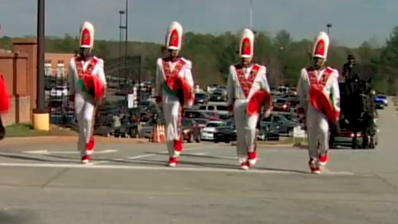 Marchers lead the funeral procession of FAMU drum major Robert Champion on November 30.