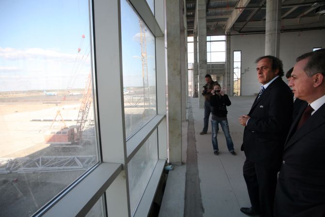Platini and deputy prime minister Boris Kolesnikov inspect work on a new terminal at Donetsk airport. The improvement work, insisted on by European football's governing body, comes at a cost of $412m, according to the Ukrainian government.