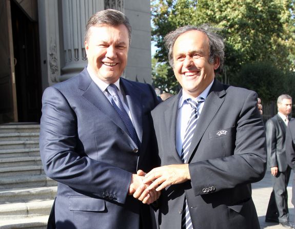 Ukrainian President Viktor Yanukovych (L) shakes hands with Michel Platini on a recent visit to the country by UEFA's president. Platini said in 2008 that Ukraine needed to "wake up" and "get going" after a series of delays.