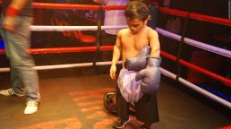 A boxer at Ringside bar in Manila's Makati district takes off his gloves after a bout.