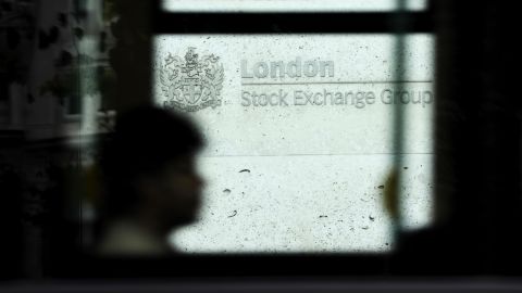 A bus passenger looks on as the bus passes by the London Stock Exchange, in central London on September 22, 2011.