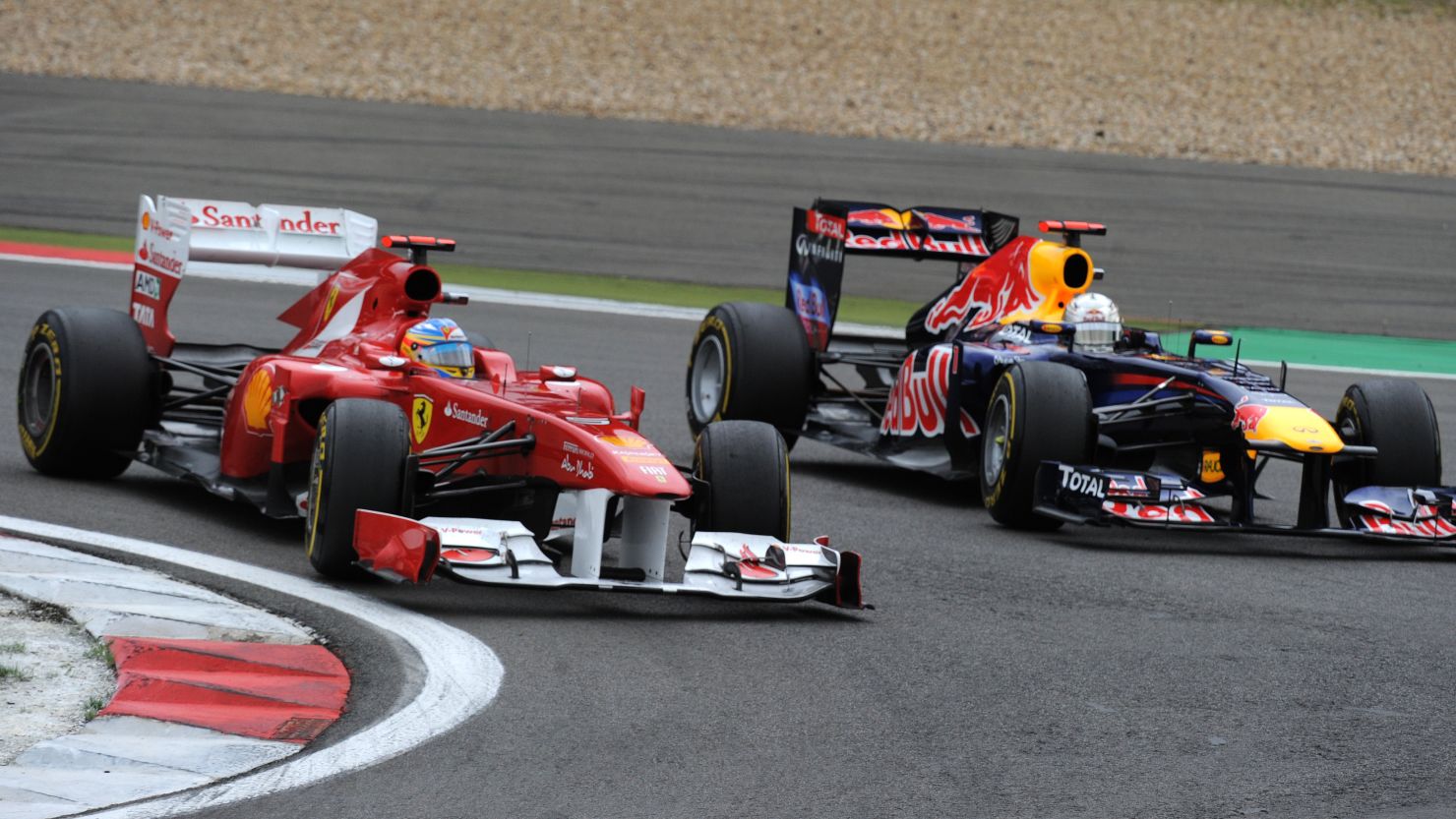 Ferrari's Fernando Alonso (L) overtakes Red Bull's Sebastian Vettel at the Nurburgring in July.