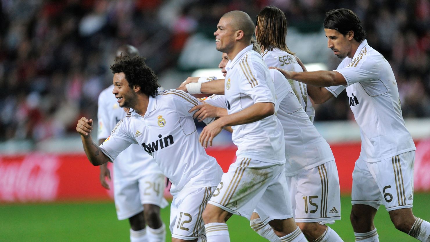 Marcelo (left) celebrates win his Real Madrid team mates after scoring the third goal in their La Liga win over Sporting Gijon 