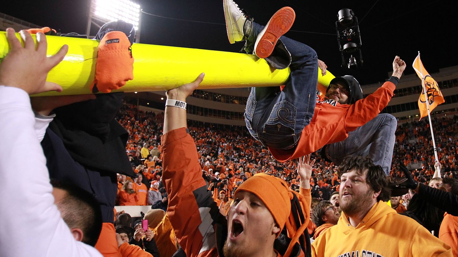 Oklahoma State football fans celebrate on the field after a 44-10 victory over rival Oklahoma on Saturday.
