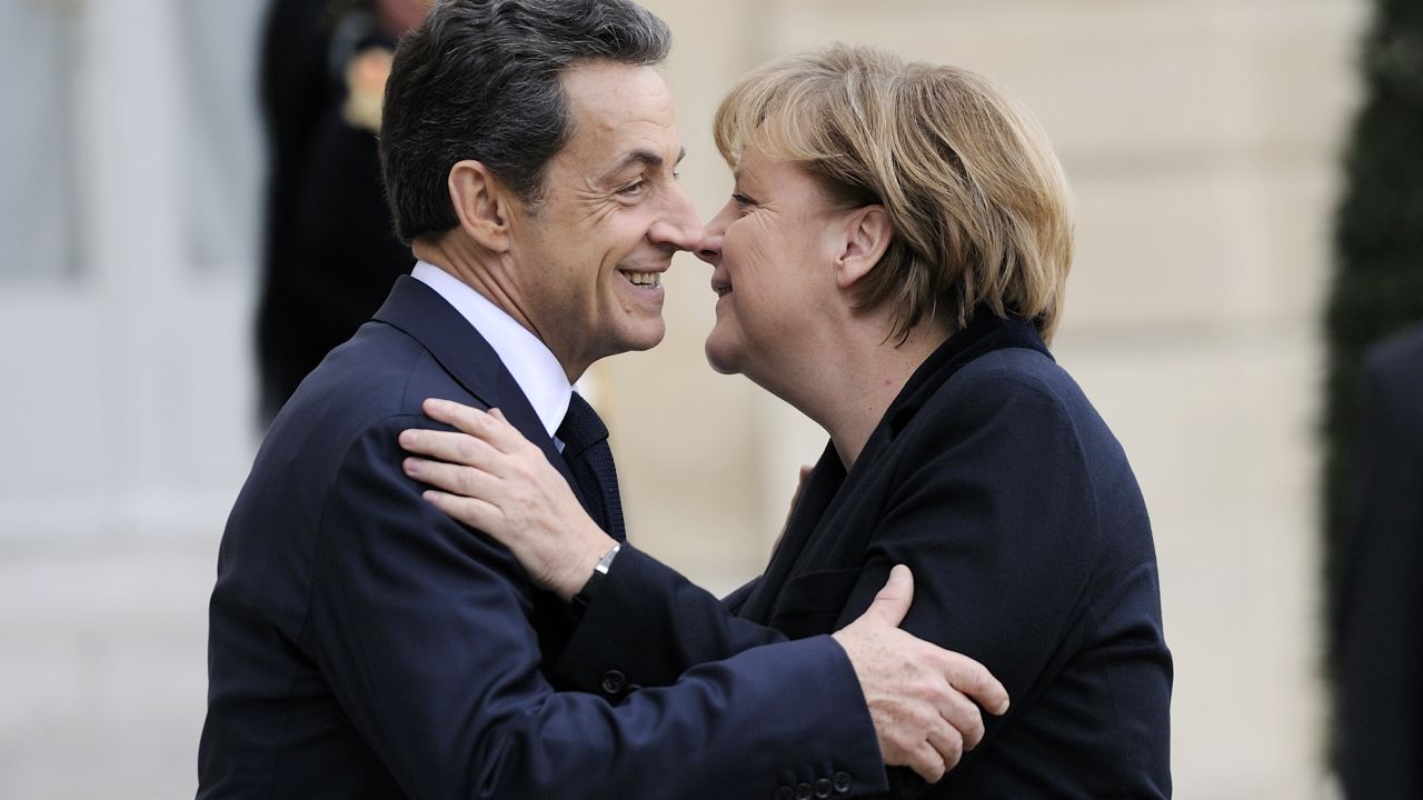 French President Nicolas Sarkozy greets German Chancellor Angela Merkel before a working lunch in Paris on Monday.