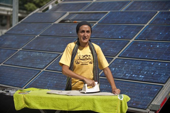 Argentinean actress and Greenpeace activist Barbara Torres using an iron powered by a solar battery. Like TVs, radios and mobile-phone chargers, irons are low-voltage electrical devices meaning their energy needs can be easily and sustainably met by solar power sources.