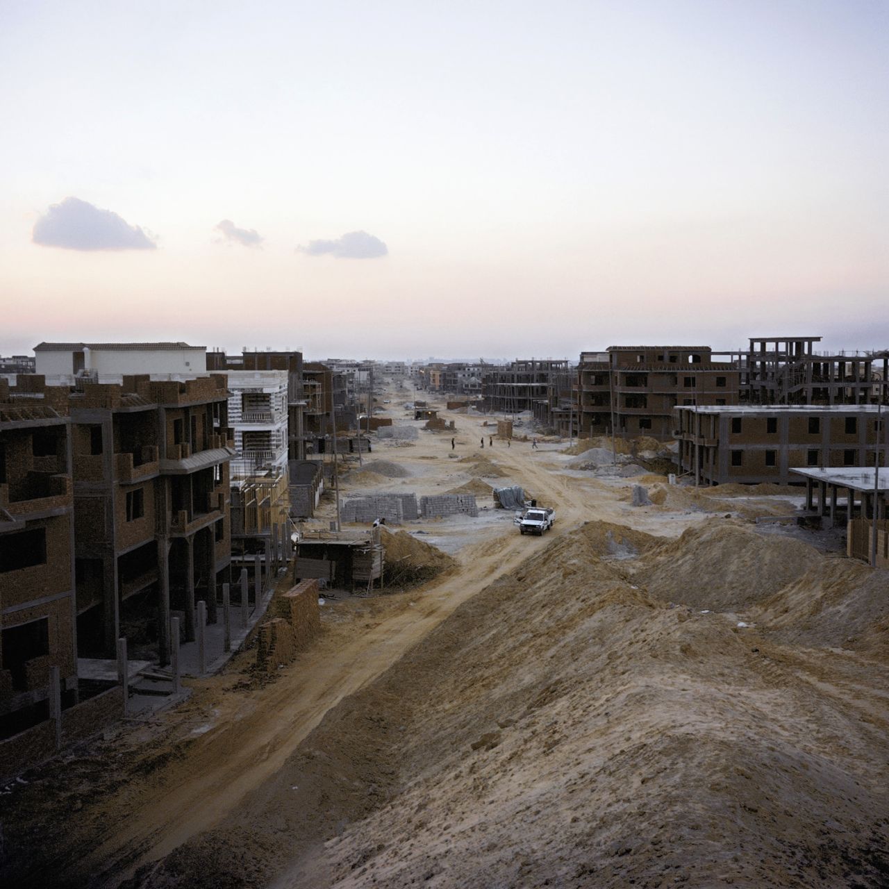 A street of individually owned villas and apartment blocks rises from the sand in New Cairo, one of the new satellite 'ghost towns.'