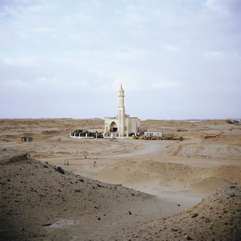 A newly-built mosque sits on land earmarked for development on the outskirts of New Cairo. Mosques are often one of the first buildings to appear when satellite cities begin taking place, in order to provide manual labourers with somewhere to pray during working hours