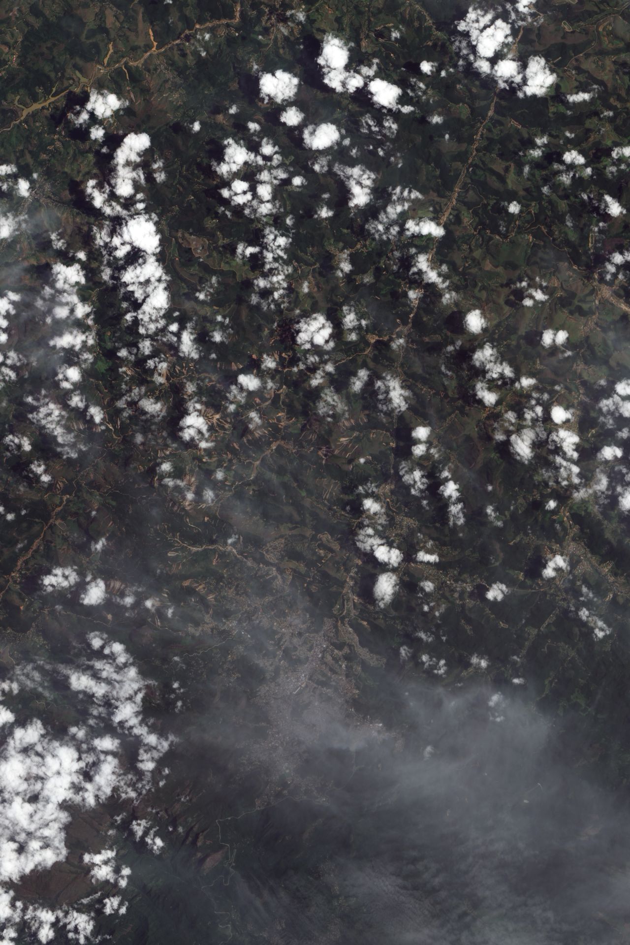 The tiny streaks of brown in this NASA image are in many instances giant <a href="http://edition.cnn.com/2011/WORLD/americas/01/18/brazil.flooding/index.html">landslides</a> which resulted from flash floods in mountainous terrain 60 kilometers north of Rio de Janeiro in January. They caused at least 900 deaths making it one of the worst natural disasters in Brazil's history, according to the World Meteorological Organization (WMO). 