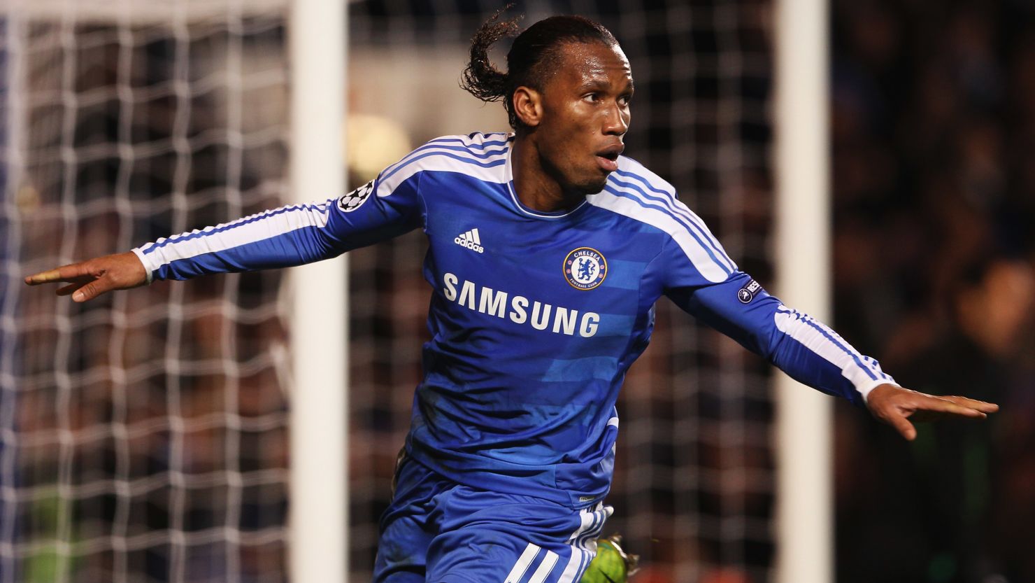 Didier Drogba celebrates his second goal as Chelsea secured their place in the Champions League last 16