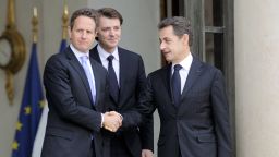 France's President Nicolas Sarkozy (R) shakes hands with US Treasury Secretary Timothy Geithner (L)  at the presidential Elysee palace in Paris.