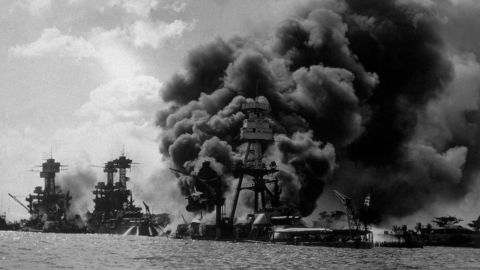 The USS Arizona burns in Pearl Harbor on December 7, 1941. To the left are the USS Tennessee and the USS West Virginia.