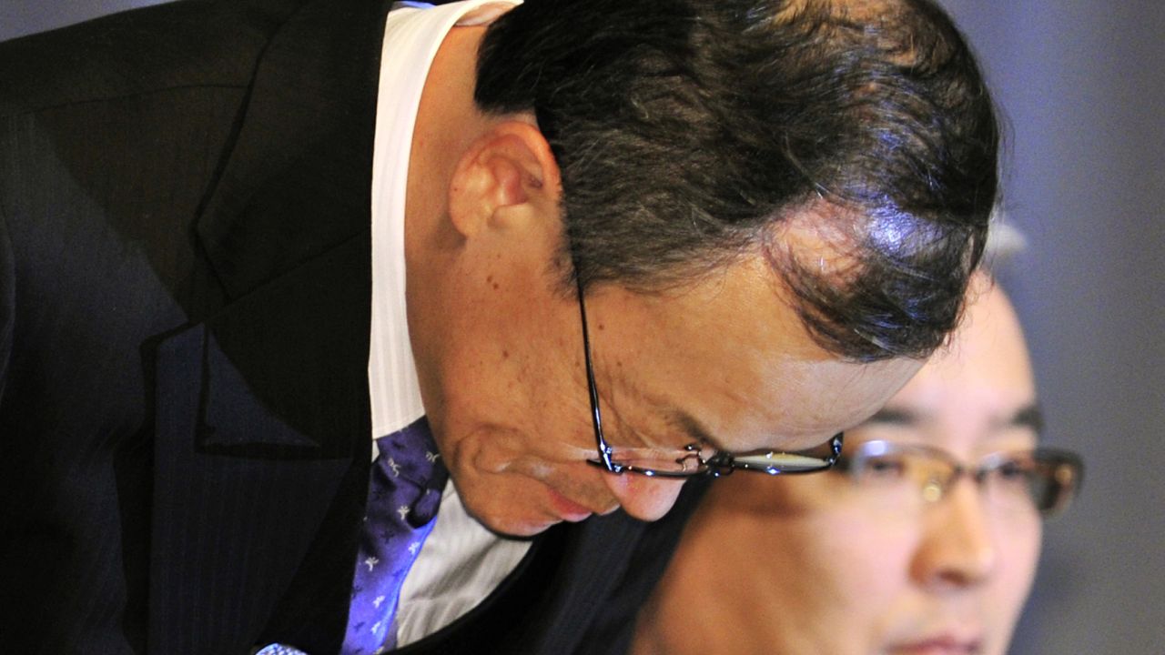 Olympus president Shuichi Takayama bows his head at a press conference in Tokyo on  Wednesday.
