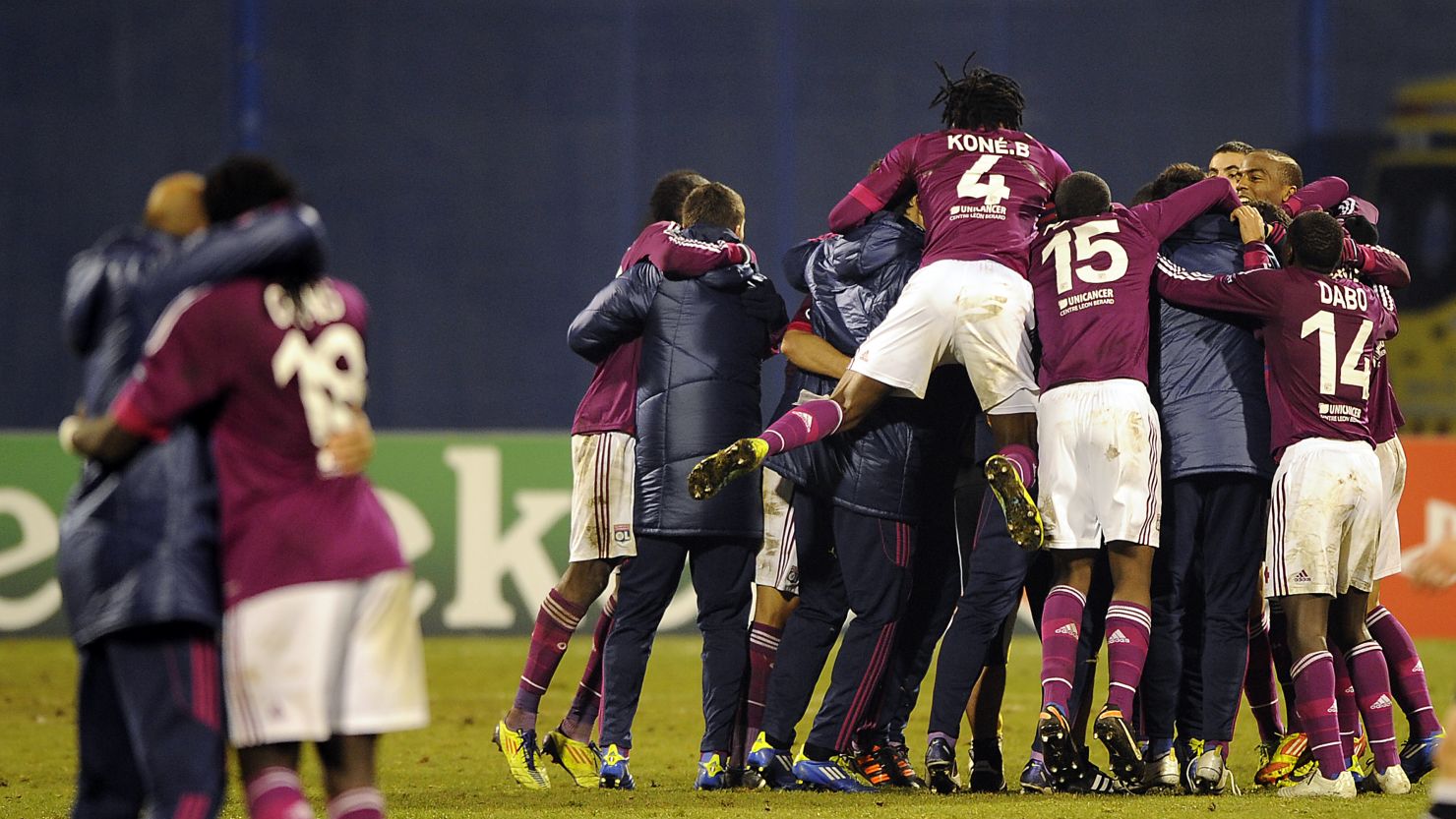 Lyon players celebrate their remarkable 7-1 victory at Dinamo Zagreb to reach the last 16 of the Champions League. 