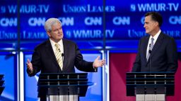 Former Speaker of the House Newt Gingrich speaks and former Massachusetts Governor Mitt Romney listens at the CNN GOP Debate at Saint Anselm College in Manchester, New Hampshire on Monday, June 13, 2011.