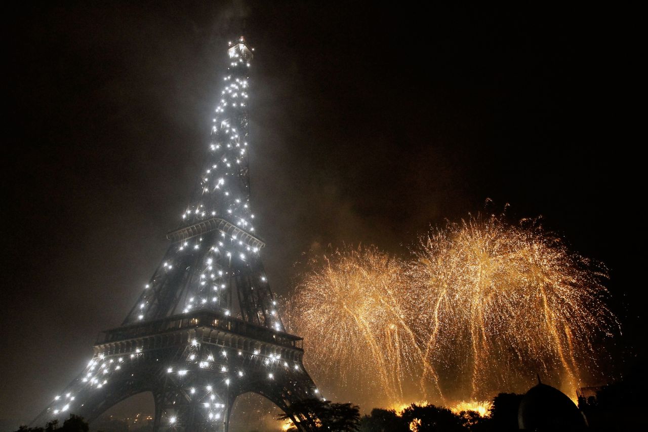 Fireworks burst over the Eiffel Tower, which is itself aglow with lights, during traditional Bastille Day celebrations on July 14, 2011.