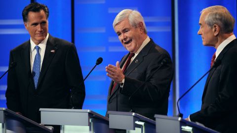 Newt Gingrich makes a point as Mitt Romney and Rep. Ron Paul listen during the Republican presidential debate in Iowa.