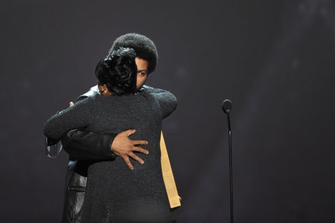 Rapper Ice Cube hugs CNN Hero Diane Latiker as she's recognized on stage.