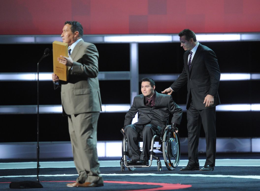 Eddie Canales asks the audience if he can bring his son onstage to share the award with him. His son was paralyzed during a high school football game in 2001. Today, Canales' nonprofit, Gridiron Heroes, provides emotional and financial support to high school football players who've sustained life-changing spinal cord injuries. 