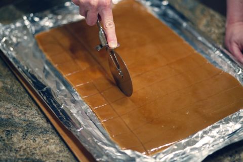 Using a pizza cutter, you can slice the toffee into whatever size squares you like.