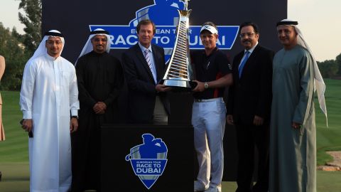 World number one Luke Donald (center right) poses with his trophy after finishing top of the European Tour money list for 2011.