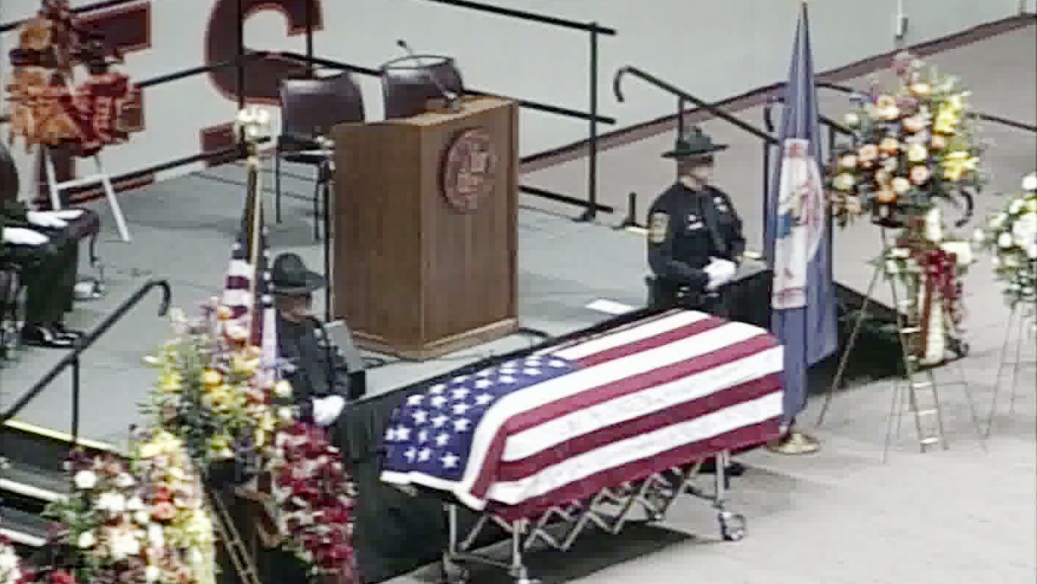 Police officers stand guard Monday over the casket of Deriek Crouse, the Virginia Tech officer who was shot to death last week.
