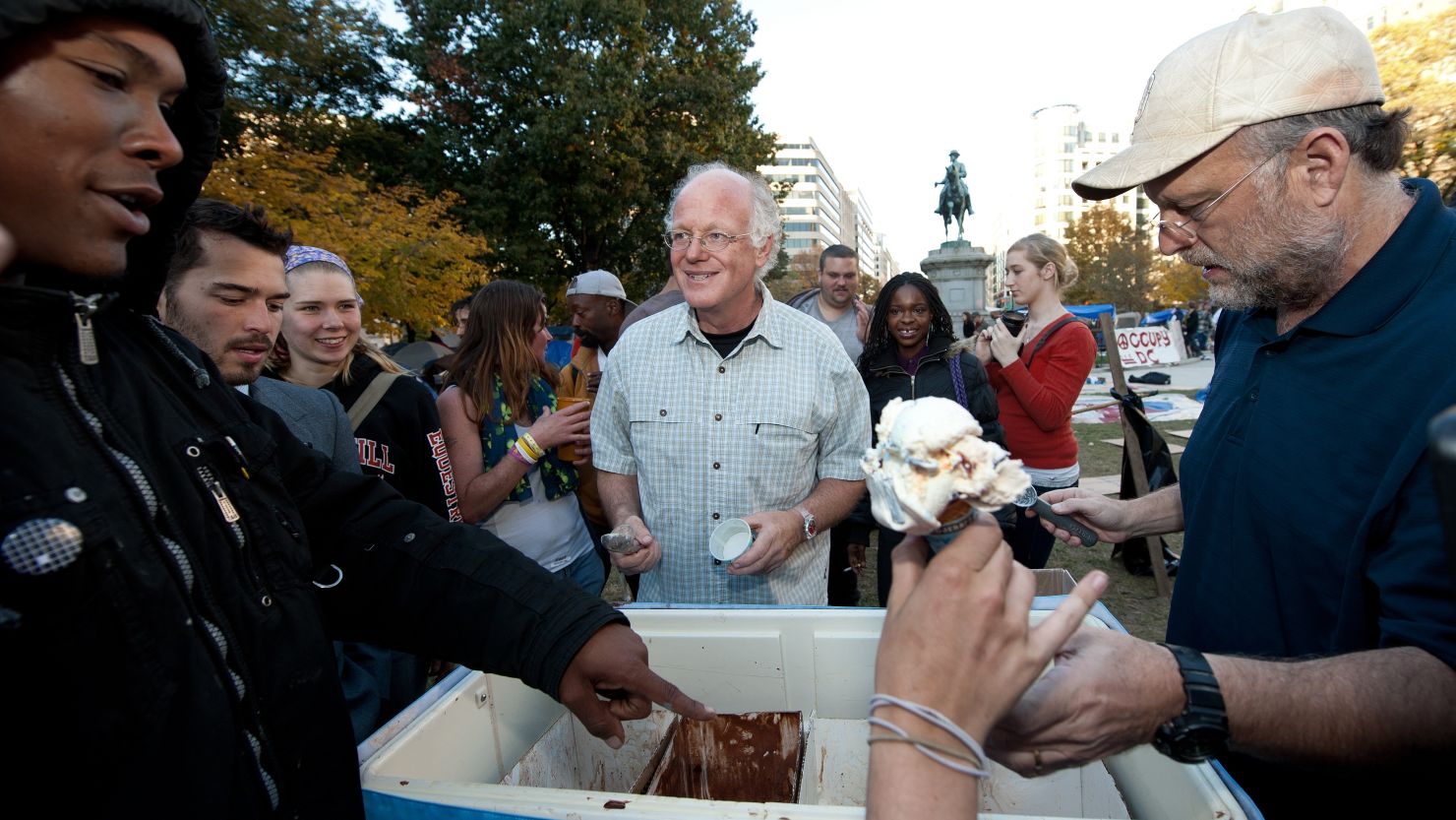 Ben Cohen, center,  and Jerry Greenfield dish out  ice cream at Occupy D.C . in  McPherson Square on November 8.