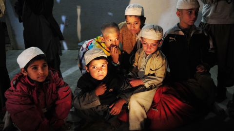 Young students sit in a room after being rescued in a police raid on a madrassa in Karachi late Monday.