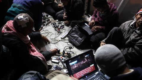 Egyptian anti-government bloggers work on their laptops from Tahrir Square during last year's uprising to oust Hosni Mubarak