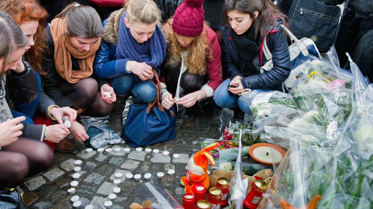  People leave tributes at the site of Tuesday's gun and grenade attack in Liege.