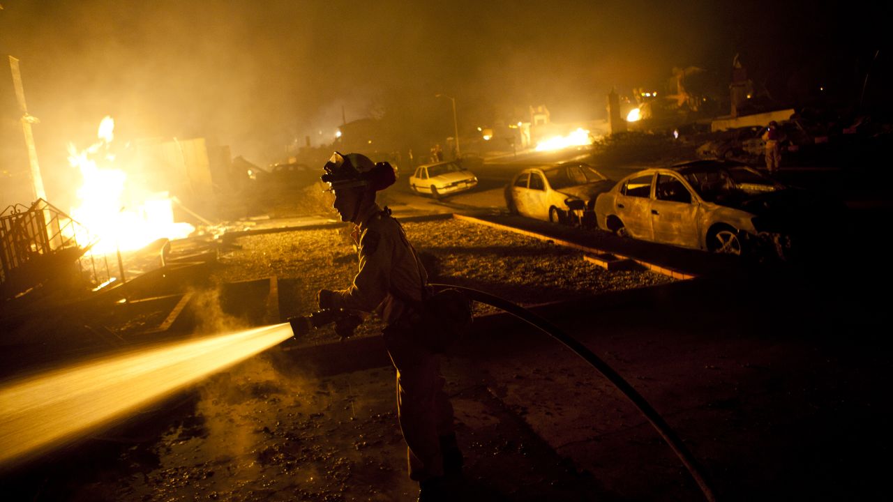 A firefighter works on a gas pipeline blaze September 9, 2010, in San Bruno, California.