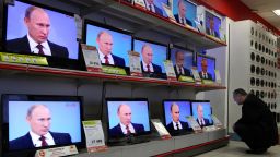 TV screens broadcasts Prime Minister Vladimir Putin's annual phone-in session with Russians in Moscow.